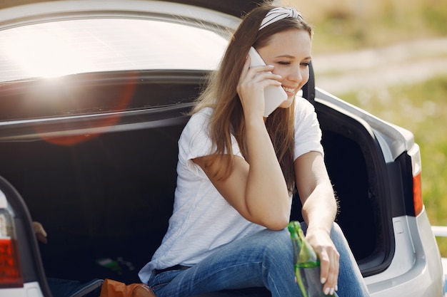 Elegant woman sitting in a trunk with water