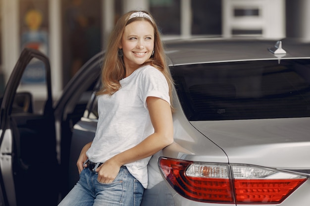 Elegant woman standing by the car