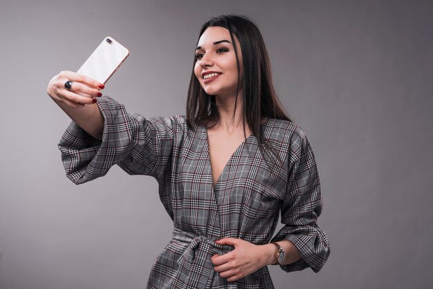 Elegant woman taking selfie