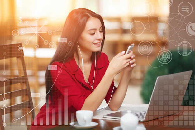 Elegant woman with a laptop listening to music