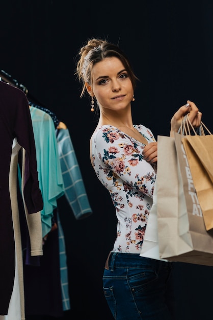 Free photo elegant woman with paper bags