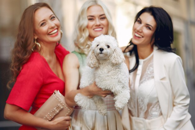 elegant women with little dog in a city