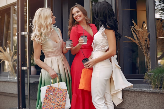 elegant women with shopping bags in a city