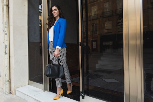 Elegant young businesswoman with blue jacket