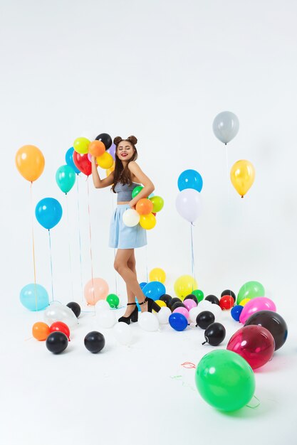 Elegant young girl posing on fancy wall after school party