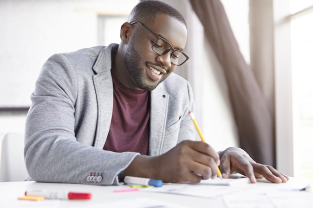 Elegant young man working in office