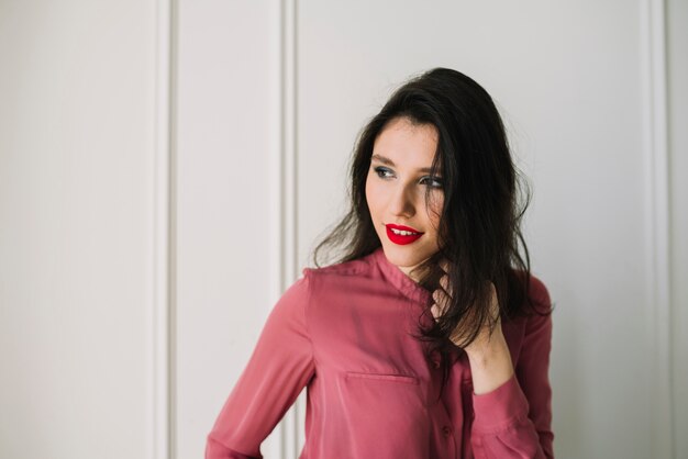 Elegant young woman in blouse in room