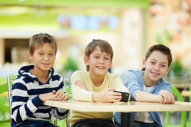 Free photo elementary students laughing outdoors