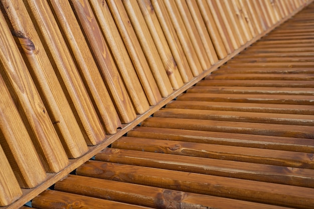 Elements of a wooden bench wooden slats Nice brown gradient Abstract background street furniture detail as background image