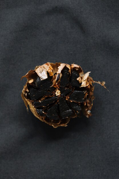 Elevated view of black garlic on dark background