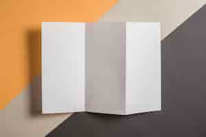 Free photo elevated view of blank white paper on multi colored background