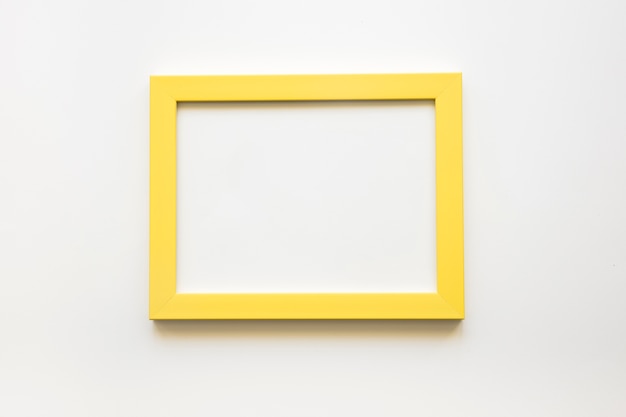 Elevated view of blank yellow frame on white background