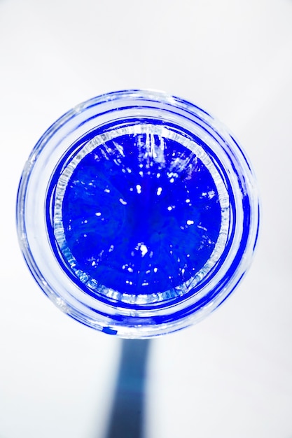 An elevated view of blue drink glass isolated on white background