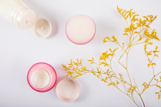 Elevated view of body lotions on white background