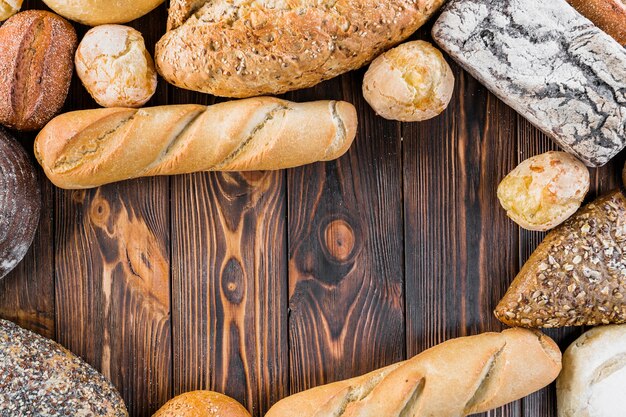 Elevated view of bread loves on dark wooden background