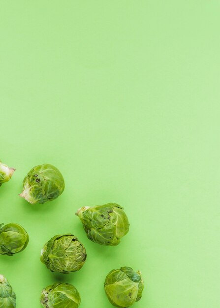 Elevated view of brussels sprouts on green surface