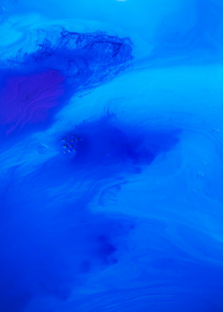 मुफ़्त फोटो an elevated view of bubbles over the mixing of blue color water paint