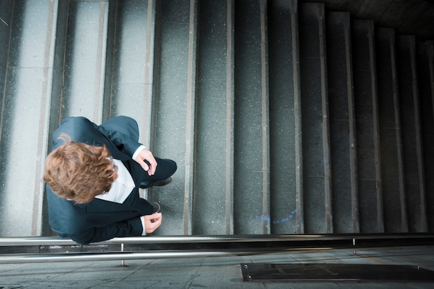 An elevated view of a businessman walking downstairs