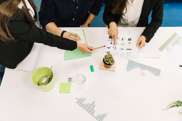 Elevated view of businesspeople planning natural resources preservation in office