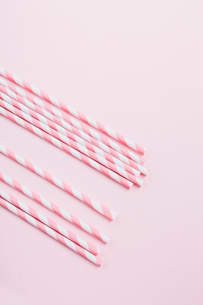 Free photo elevated view of candy canes on pink background