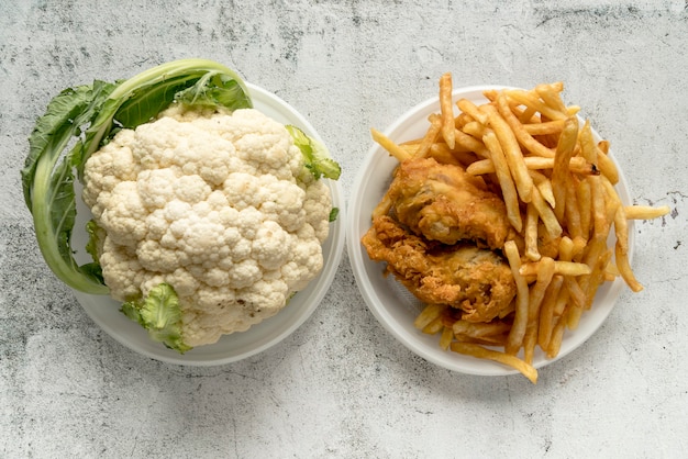 Elevated view of cauliflower and fried food over concrete background
