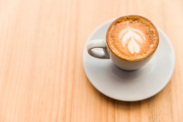 Elevated view of coffee latte on wooden surface
