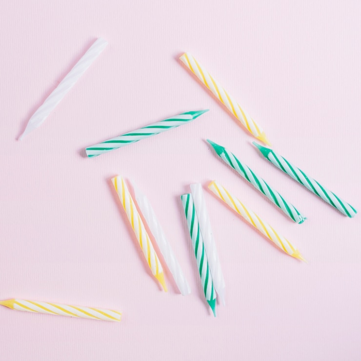 Free Photo elevated view of colorful candles on white background