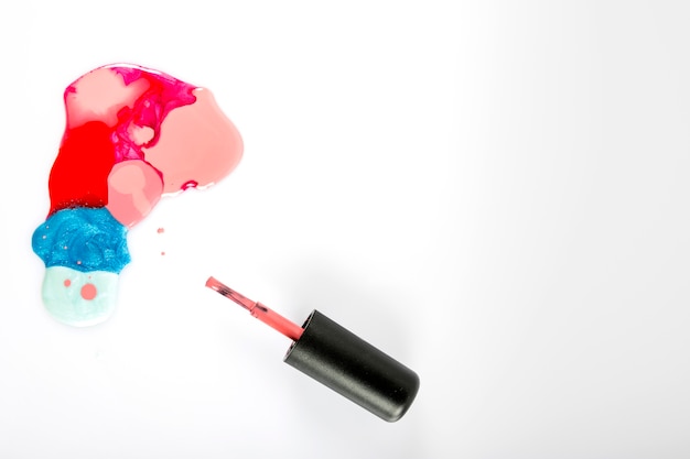 Elevated view of colorful nail polish on white background