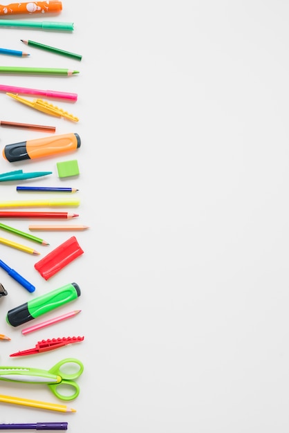 Elevated view of colorful school accessories on white backdrop