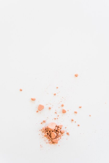 Elevated view of crush compact powder on white backdrop
