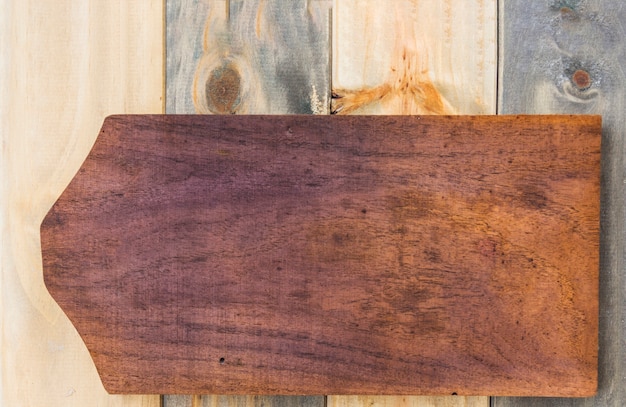 Elevated view of cutting board on wooden backdrop