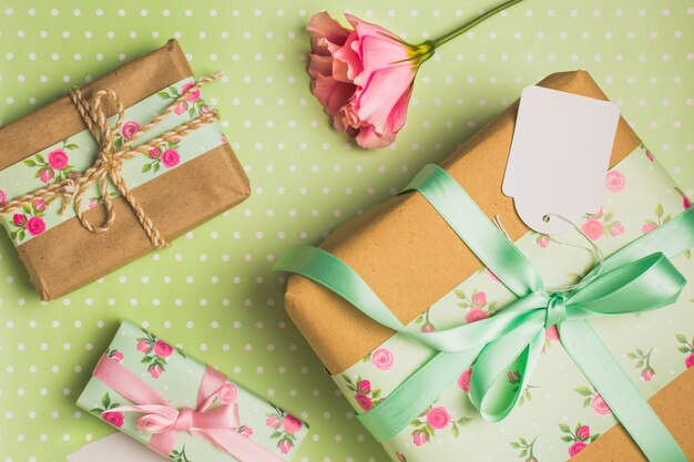 Elevated view of decorative wrapped beautiful gift box on polka dotted backdrop