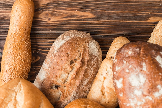 Elevated view of delicious baked breads on wooden backdrop