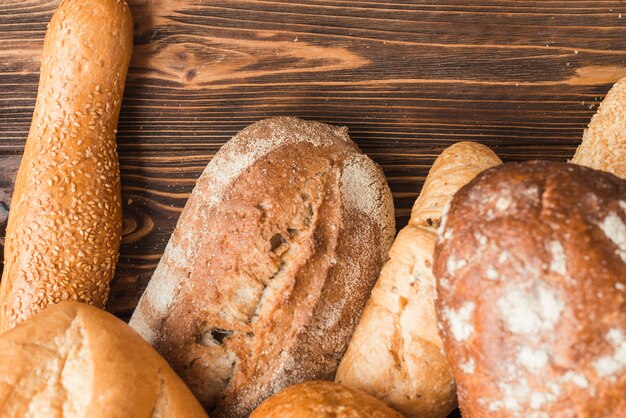 Elevated view of delicious baked breads on wooden backdrop