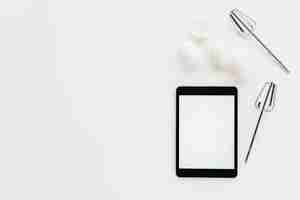 Free photo elevated view of digital tablet with whisk and eggs on white background