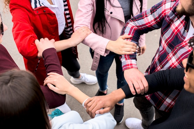 Elevated view of divers friends holding each others hands standing on street