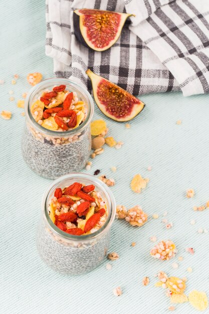 Elevated view of fig slices; cloth and chia smoothie in transparent jar