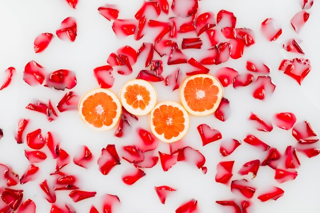 Elevated view of flower petals and grapefruit slices