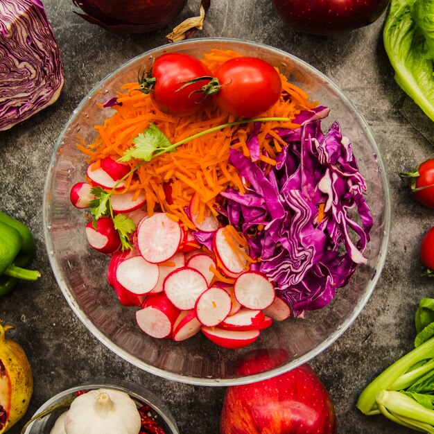 Elevated view of fresh chopped salad in transparent bowl