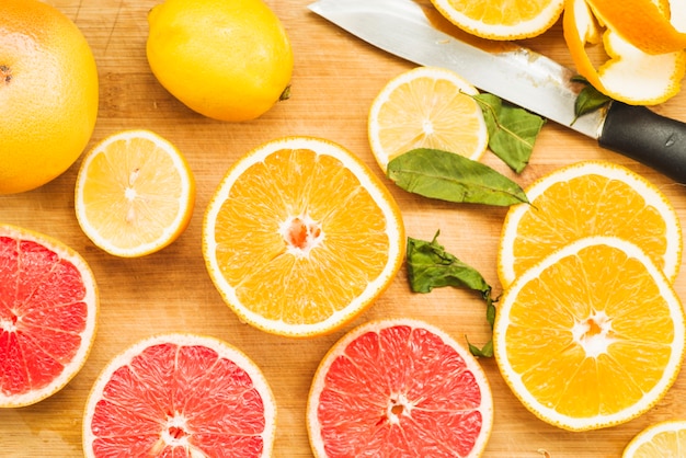 Elevated view of fresh citrus fruits on wooden backdrop