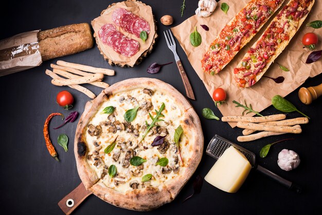 Elevated view of fresh delicious italian food with ingredients on black surface