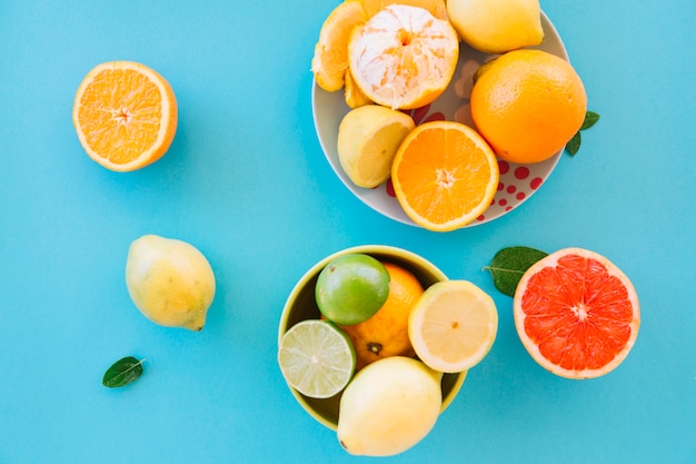 Elevated view of fresh juicy fruits on blue background