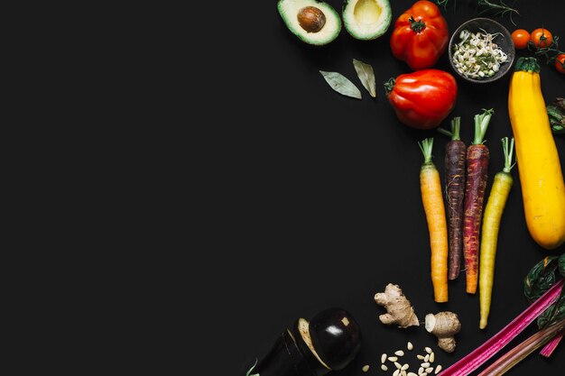 Elevated view of fresh vegetables on black backdrop