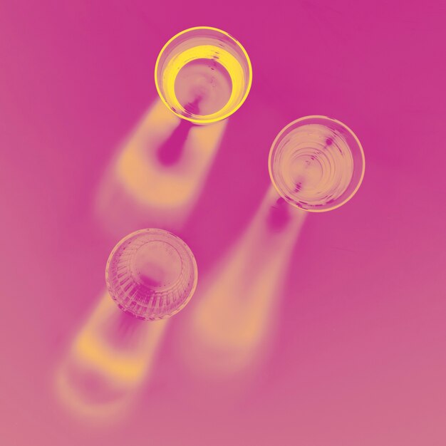 An elevated view of glasses on pink backdrop