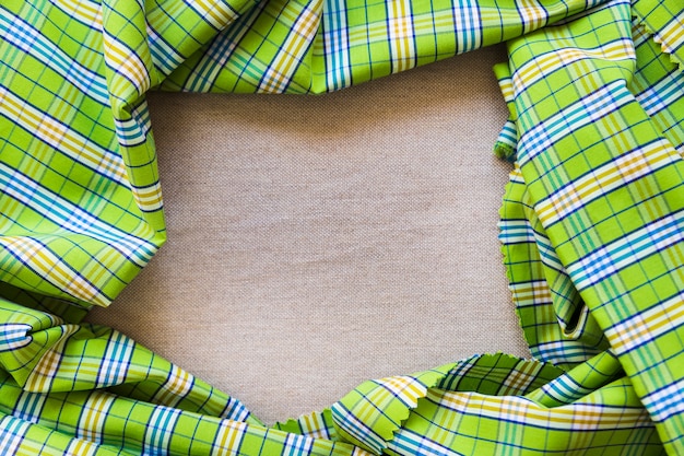 Elevated view of green plaid pattern textile forming frame