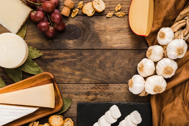 Elevated view of healthy cheese and ingredient on wooden surface