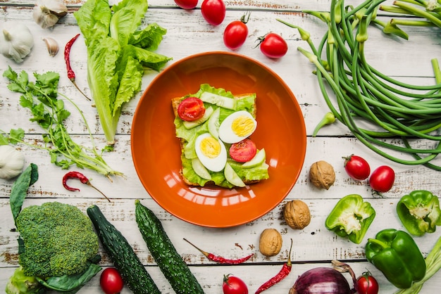 Elevated view of healthy egg and vegetables sandwich in bowl