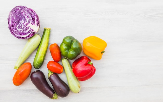 Elevated view of healthy raw vegetables on wooden backdrop