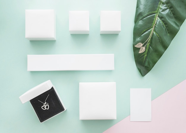 Elevated view of jewelry boxes on pastel colored backdrop