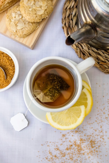Elevated view of lemon tea and brown sugar on table